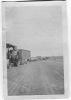Photo of Wilbur Cleo Davis in front of tractor wheel